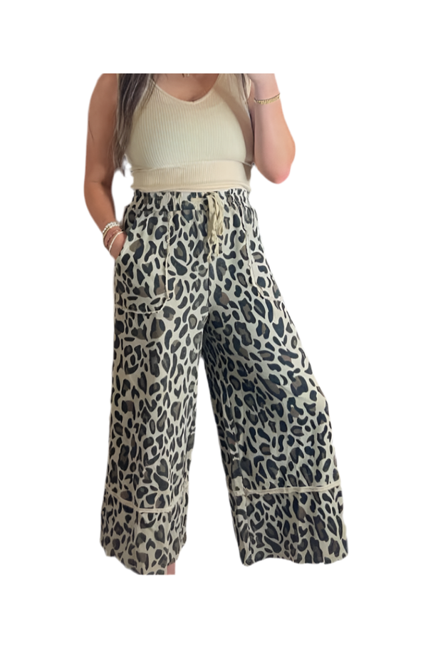 Leopard print wide-leg pants worn by a person on a white background