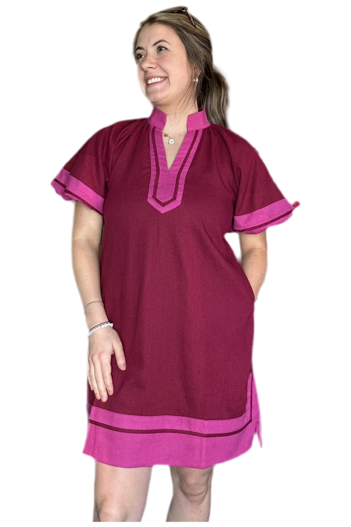 Woman wearing a maroon and pink dress on a white background