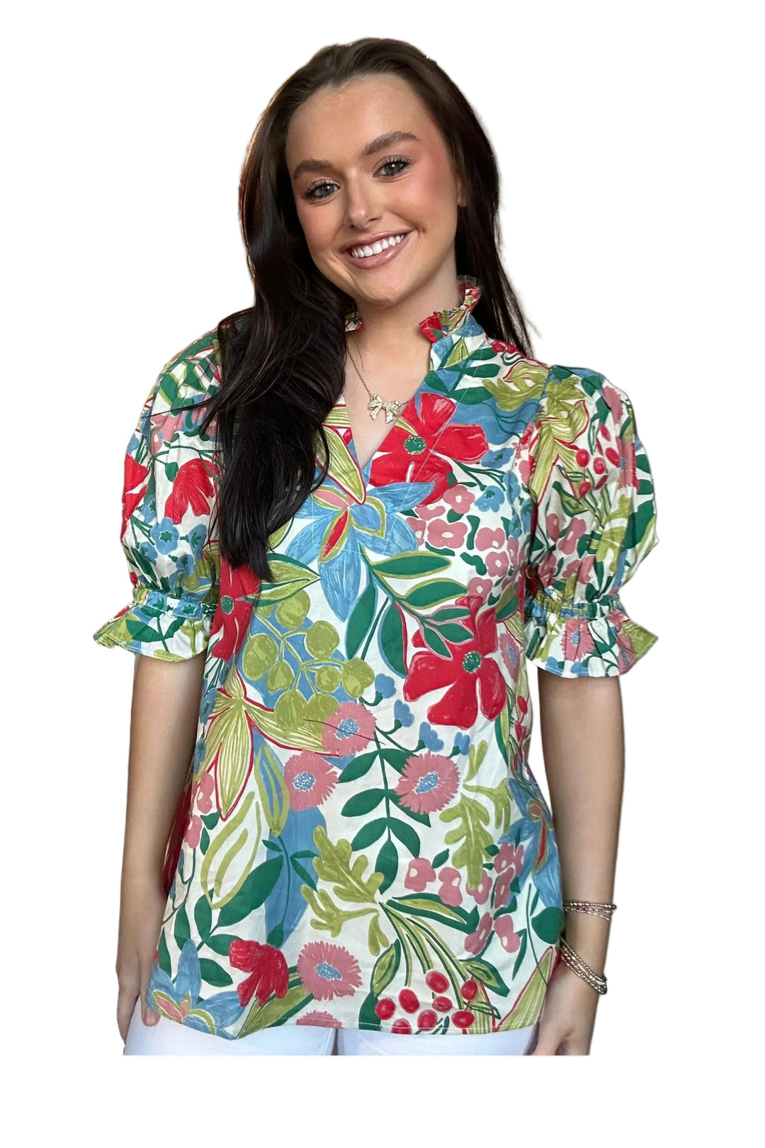 Woman wearing a colorful floral blouse in a clothing store.