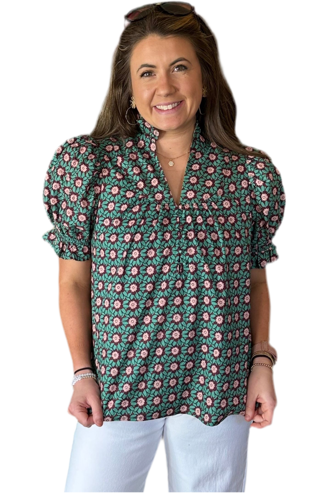 Woman wearing a floral blouse with puff sleeves on a white background