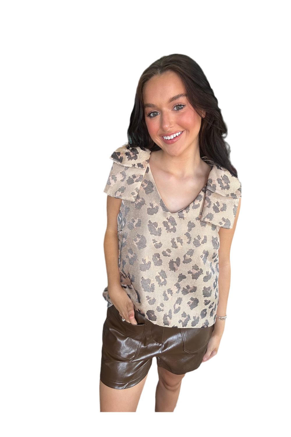 Woman wearing a patterned blouse and brown shorts on a white background