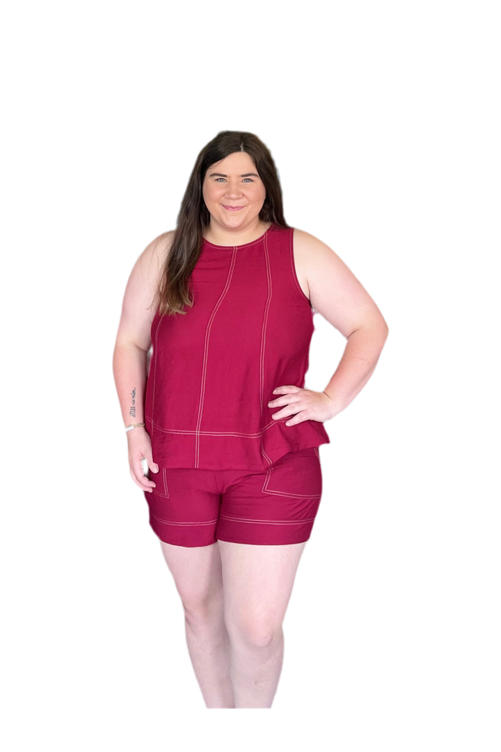 Woman wearing a red outfit with shorts on a white background
