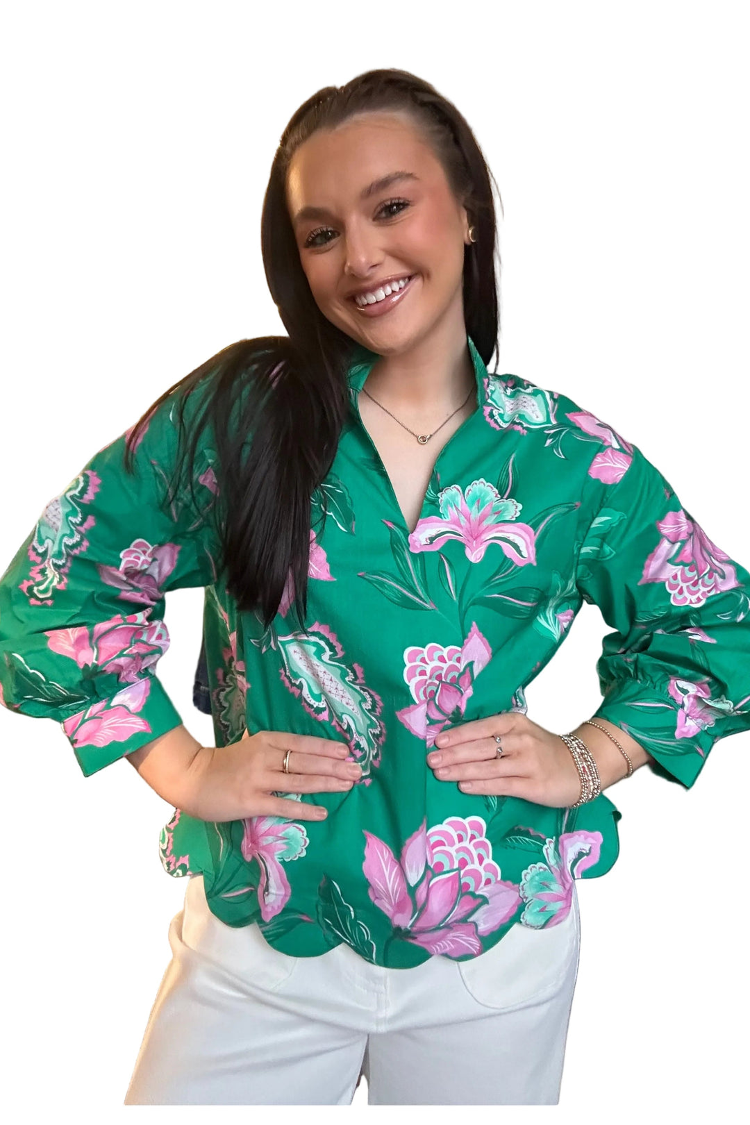 Woman wearing a green floral blouse in a clothing store