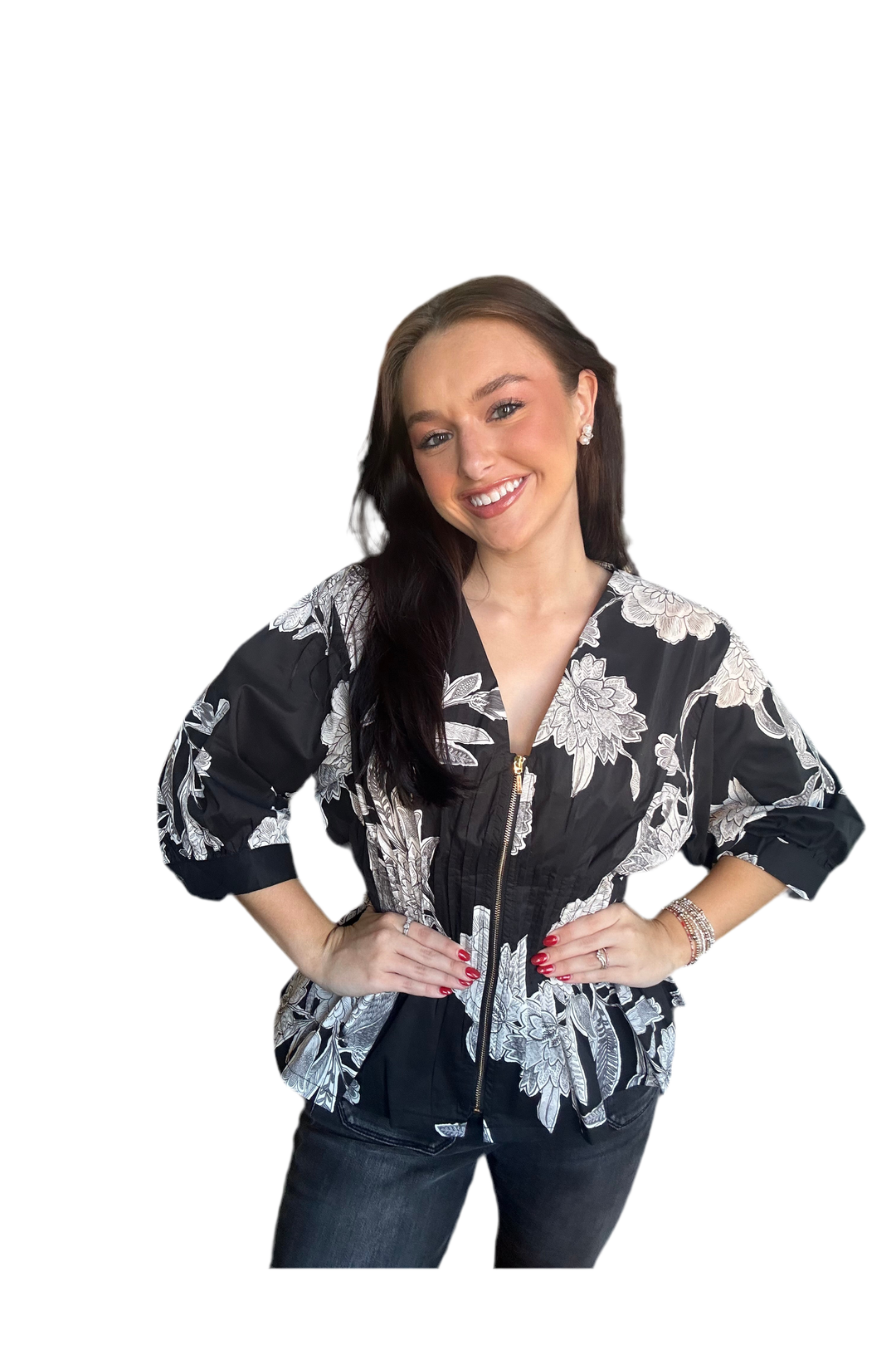 Woman wearing a black with white floral print zipper blouse