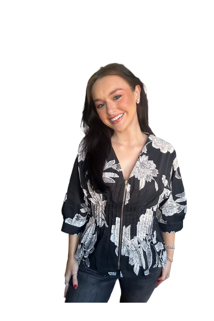 Woman wearing a black floral zipper blouse 