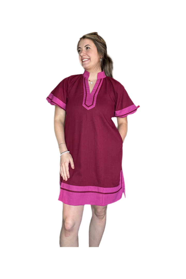 Woman wearing a maroon and pink dress on a white background
