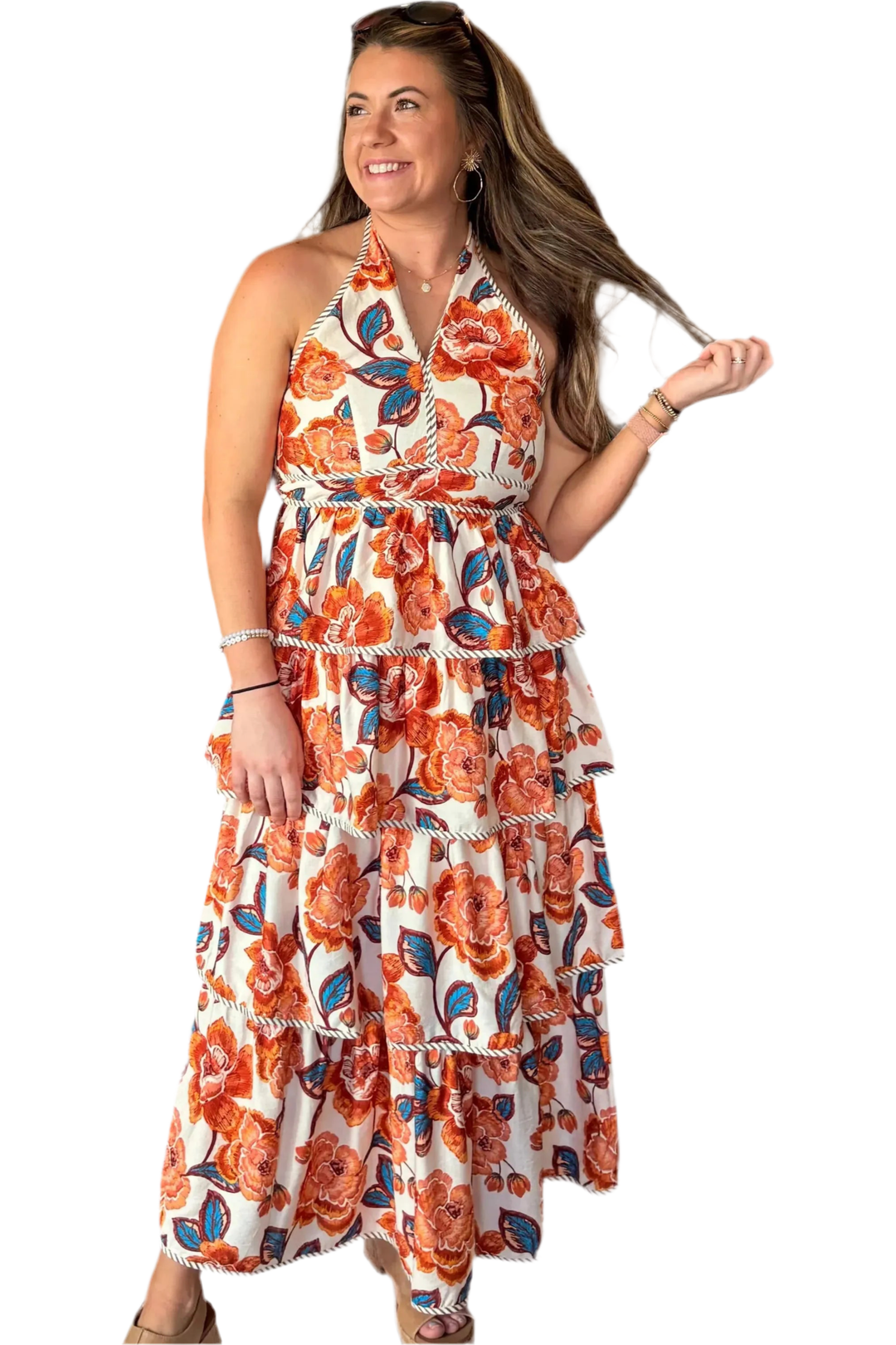 Woman wearing a floral dress with orange and blue patterns on a white background