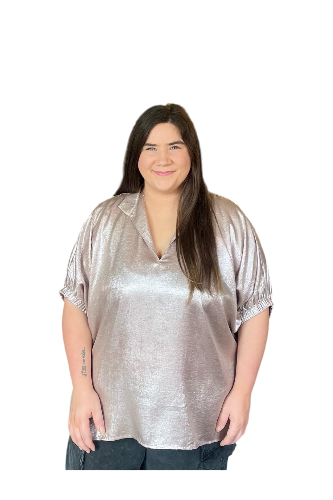 Woman wearing a champagne or gold metallic blouse on a white background