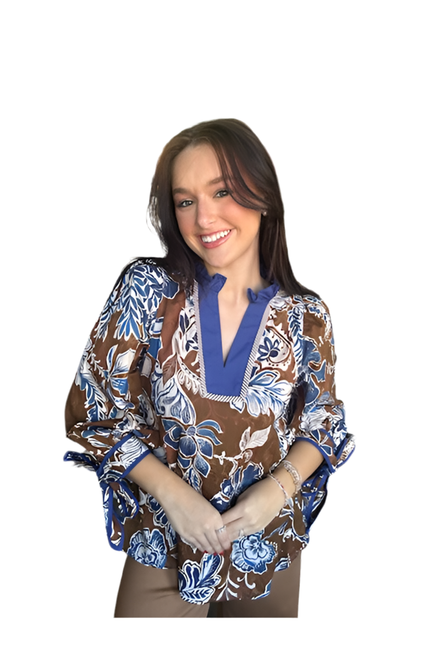 Woman wearing a brown and blue patterned blouse on a white background