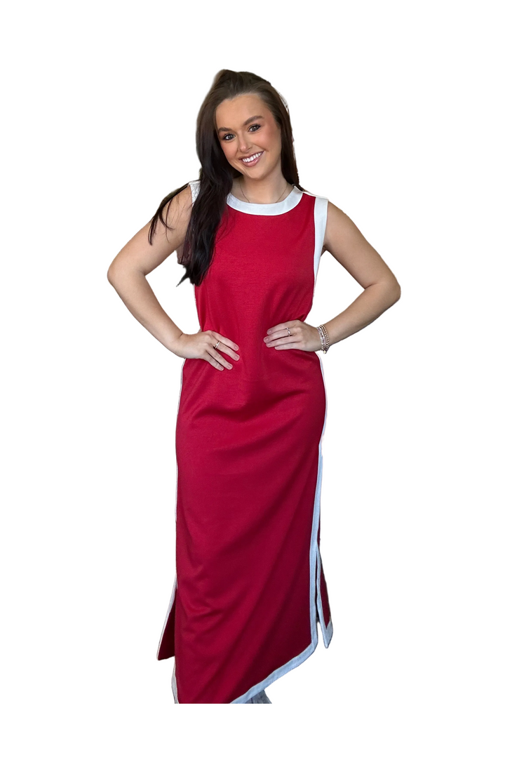 Woman wearing a red dress with white trim on a white background