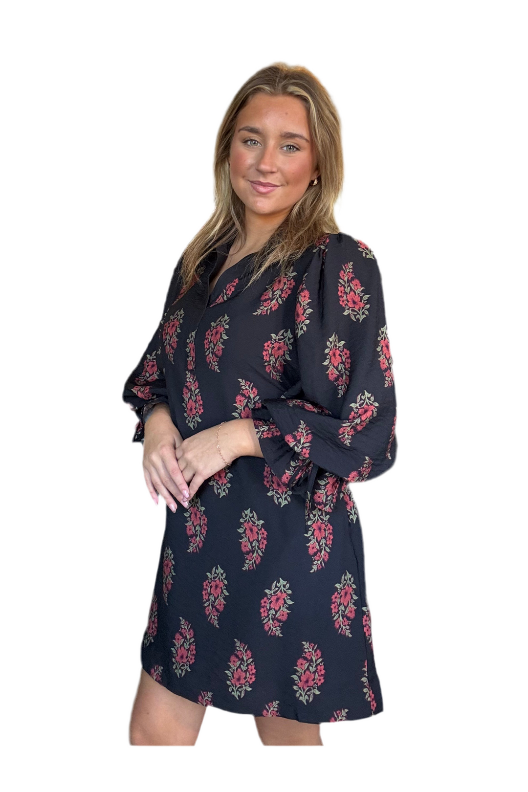 Woman wearing a black floral dress on a white background