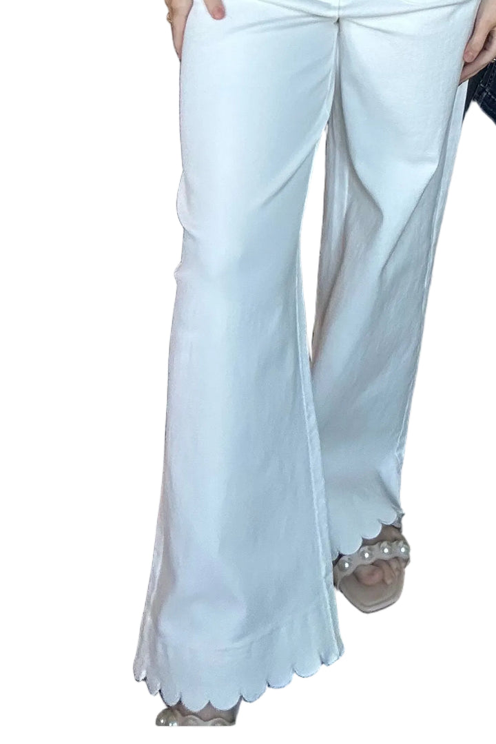 White pants with scalloped hem on a white background