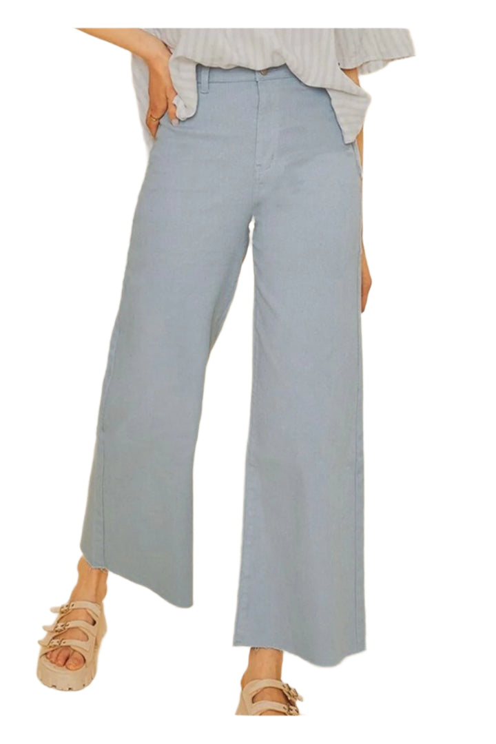 Light blue wide-leg pants worn by a person on a beige background