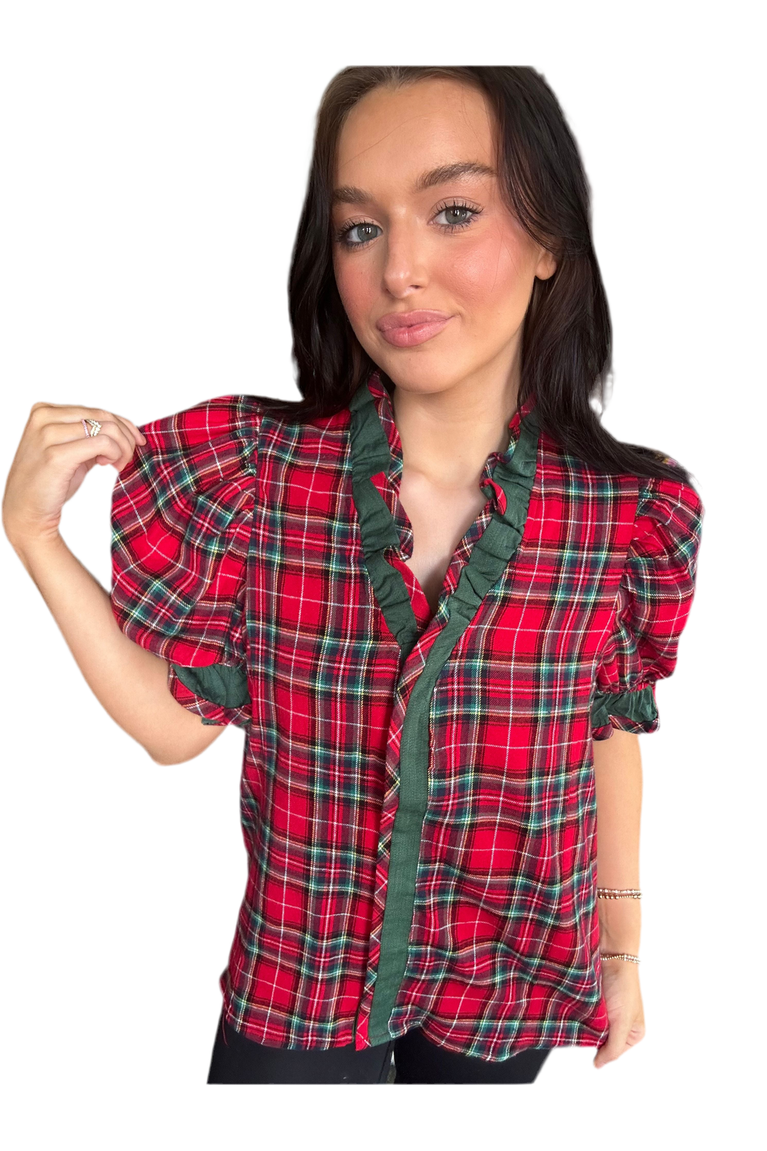 Woman wearing a red plaid shirt with green trim on a white background