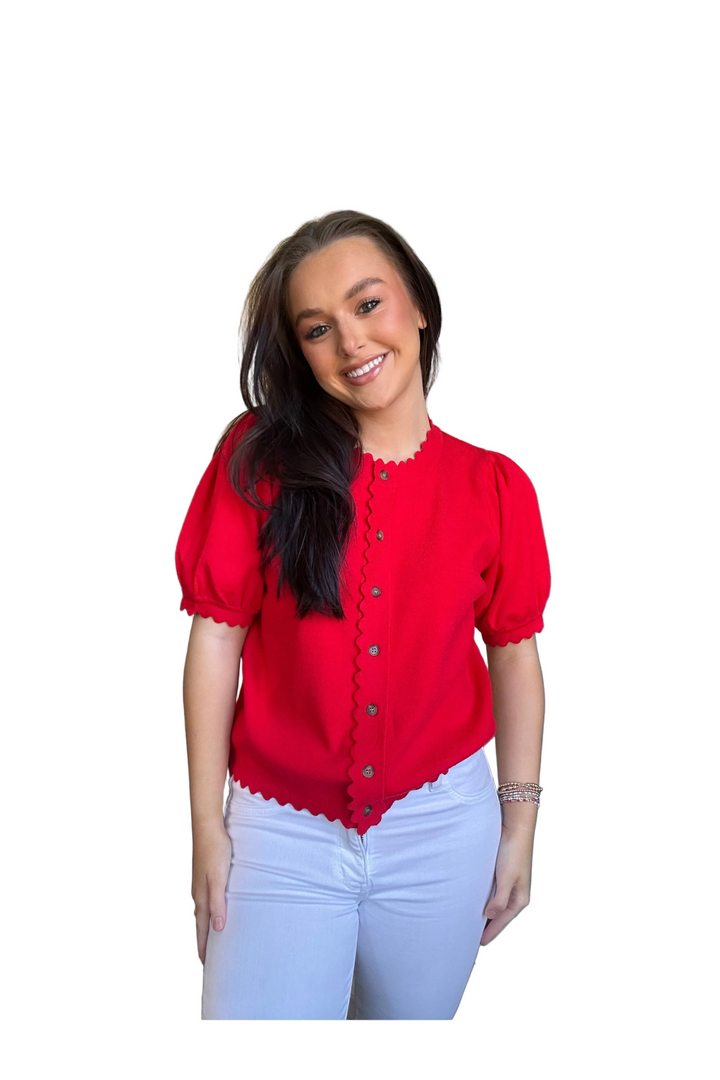 Woman wearing a red blouse with puff sleeves on a white background