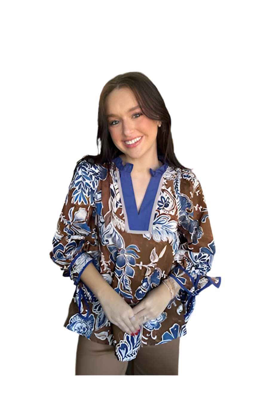 Woman wearing a patterned blouse with a plain background