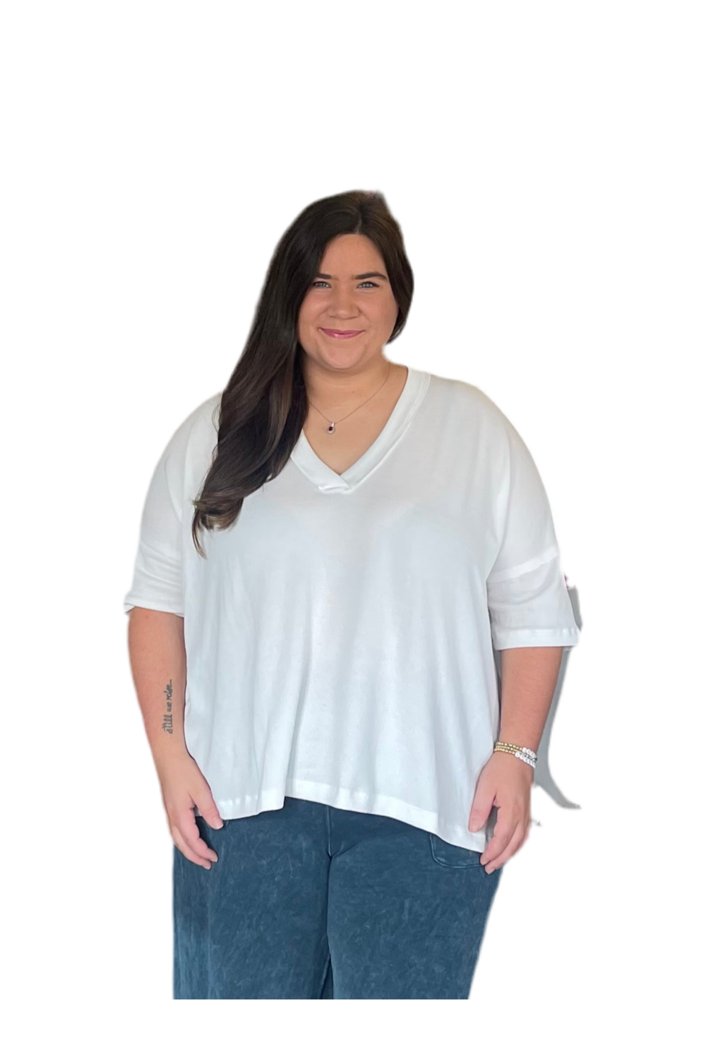 Woman wearing a white blouse and blue pants on a white background