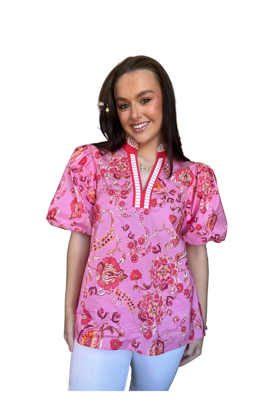 Woman wearing a pink floral blouse with a white background
